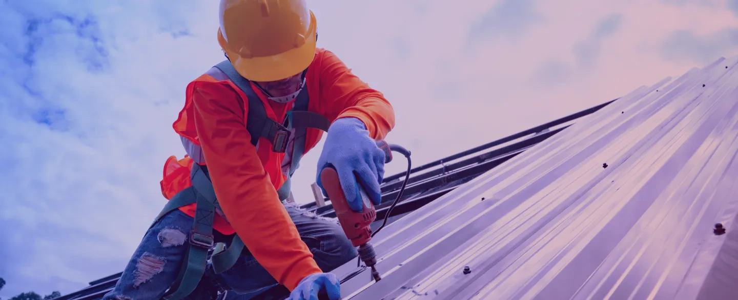 man using driller roof construction osage beach mo